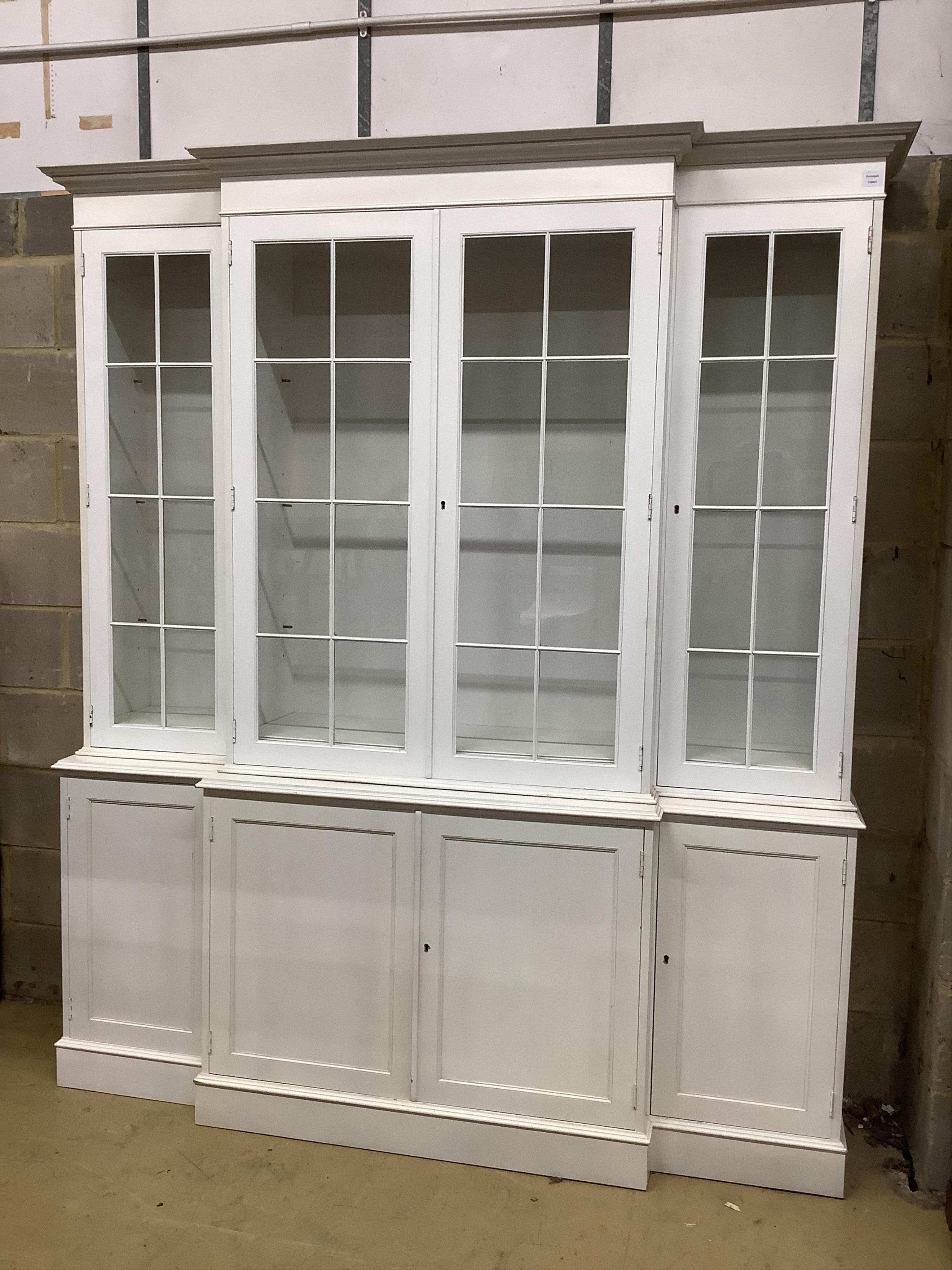 A reproduction George III style painted breakfront library bookcase, width 192cm, depth 40cm, height 219cm. Condition - fair